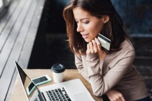Young,Woman,Holding,Credit,Card,And,Using,Laptop,Computer.,Businesswoman